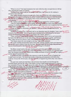 A printed manuscript page covered in red handwritten editing marks and margin notes